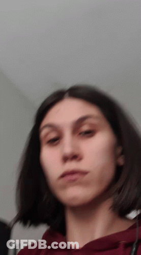 A Blurry Picture Of A Girl With Short Hair GIF
