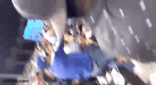 A Blurry Picture Of A Group Of People Sitting In A Stadium . GIF