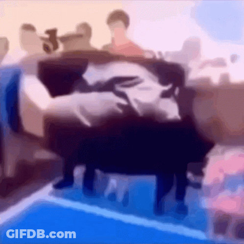 A Blurry Picture Of A Group Of People Sitting On A Bed GIF