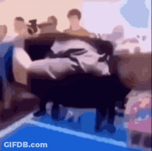A Blurry Picture Of A Group Of People Sitting On A Couch In A Room . GIF