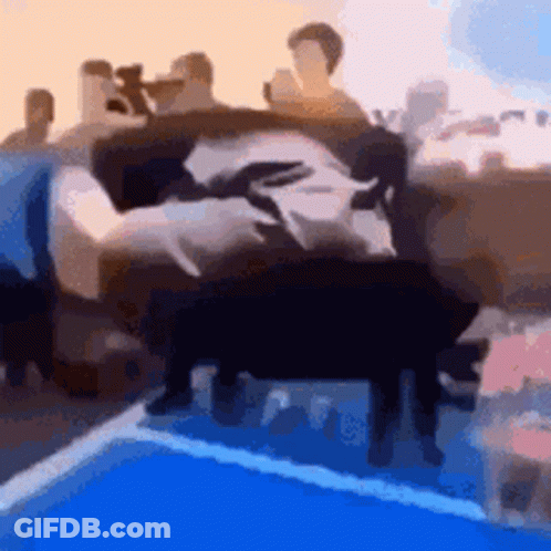 A Blurry Picture Of A Group Of People Sitting On A Couch In Front Of A Pool . GIF