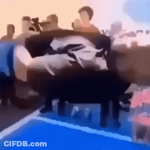 A Blurry Picture Of A Group Of People Standing Around A Swimming Pool . GIF