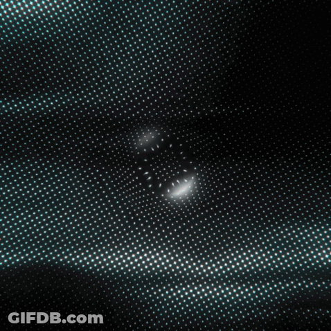 A Blurry Picture Of A Group Of People Standing In A Room . GIF
