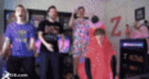 A Blurry Picture Of A Group Of People Standing In Front Of A Sign That Says Z. GIF