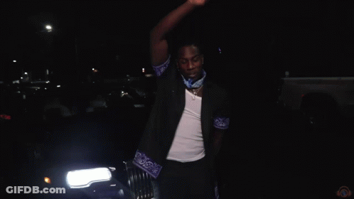 A Blurry Picture Of A Group Of People With The Letter M In The Middle GIF