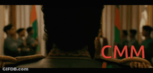 Blurry Group Of People With CMM Sign GIF