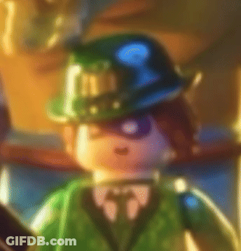 A Blurry Picture Of A Lego Batman Character Wearing A Hat And Tie . GIF