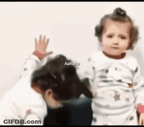 A Blurry Picture Of A Little Girl And A Dog With The Words '  Hahaha ' On The Bottom GIF