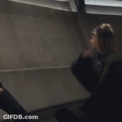 A Blurry Picture Of A Man And A Woman Fighting GIF