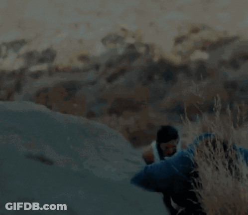 A Blurry Picture Of A Man And A Woman Hiking Up A Hill GIF