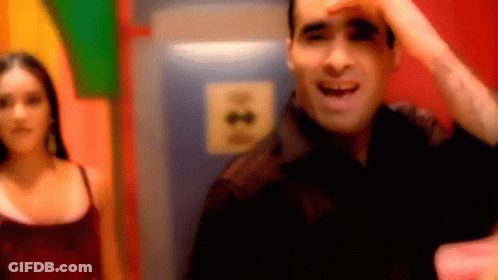 A Blurry Picture Of A Man And A Woman In A Room With A Sign That Says ' A ' On It GIF
