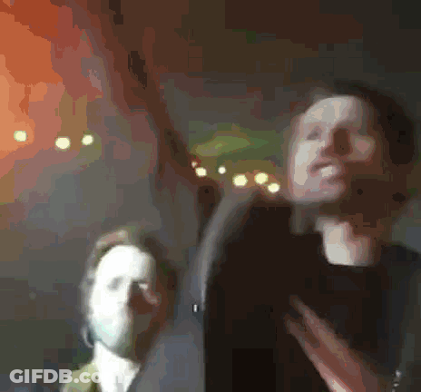 A Blurry Picture Of A Man And A Woman GIF