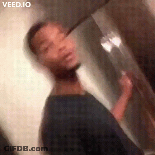 A Blurry Picture Of A Man Brushing His Teeth In A Bathroom GIF