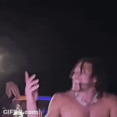 A Blurry Picture Of A Man Dancing With A Purple Light Behind Him GIF