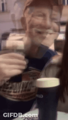 A Blurry Picture Of A Man Drinking From A Can Of Bud Light GIF