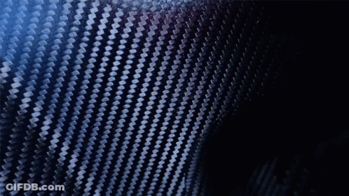 A Blurry Picture Of A Man Holding A Black Object In His Hand GIF