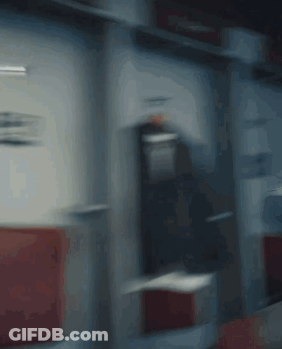 A Blurry Picture Of A Man Holding A Red Fire Extinguisher GIF