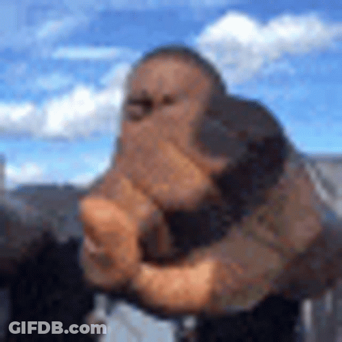 A Blurry Picture Of A Man Holding His Fist Up In The Air . GIF