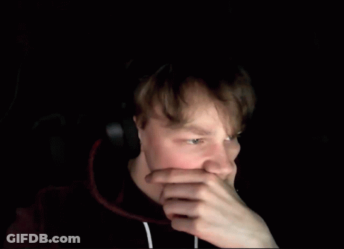 A Blurry Picture Of A Man Holding His Head With His Hands . GIF