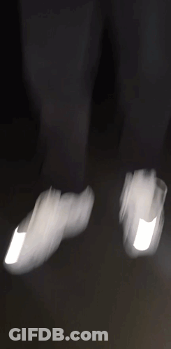 A Blurry Picture Of A Man In A Black Jacket Holding A Gun . GIF