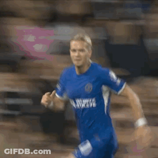 A Blurry Picture Of A Man In A Blue Jersey GIF