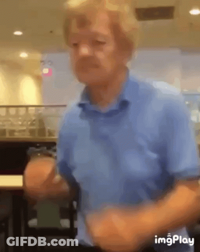A Blurry Picture Of A Man In A Blue Shirt Dancing GIF