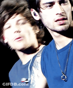 A Blurry Picture Of A Man In A Blue Shirt GIF