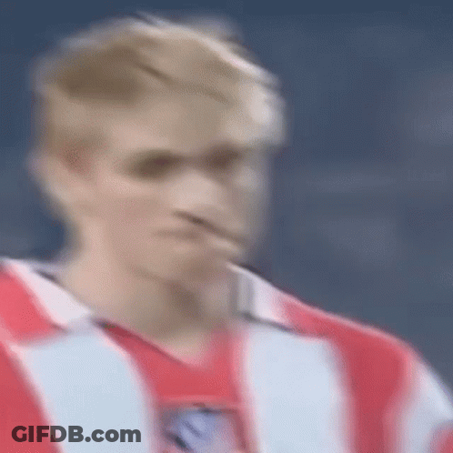 A Blurry Picture Of A Man In A Red And White Striped Shirt . GIF
