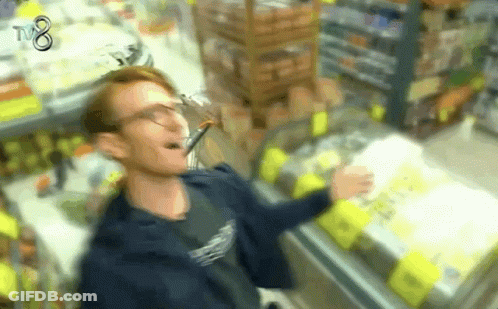 A Blurry Picture Of A Man In A Store With Tv8 On The Bottom GIF