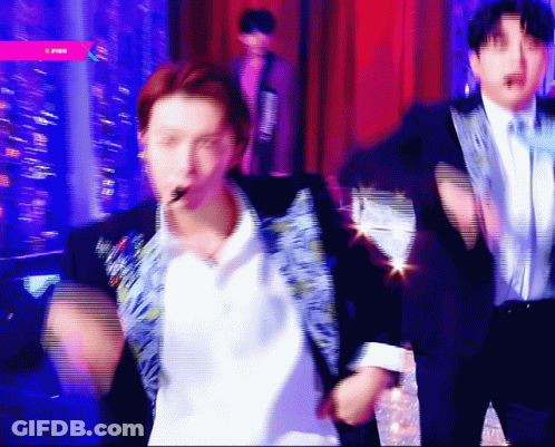 A Blurry Picture Of A Man In A Suit And Tie Dancing GIF