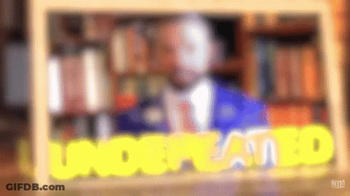 A Blurry Picture Of A Man In A Suit And Tie With The Words Understood In Yellow Letters . GIF