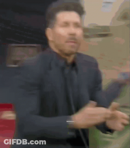 A Blurry Picture Of A Man In A Suit Dancing GIF
