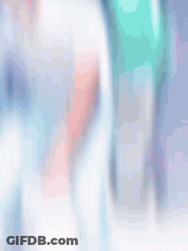 A Blurry Picture Of A Man In A White Shirt GIF