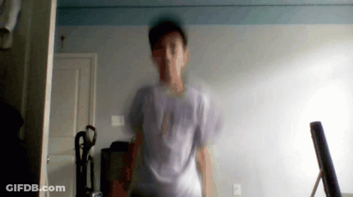 A Blurry Picture Of A Man In A White Shirt With The Word Abercrombie On The Front GIF