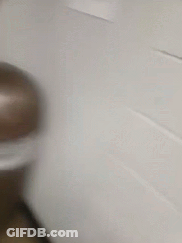 A Blurry Picture Of A Man In A Yellow Jacket Taking A Picture Of Himself In A Mirror GIF