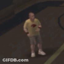 A Blurry Picture Of A Man In A Yellow Shirt And Shorts Standing On A Basketball Court . GIF