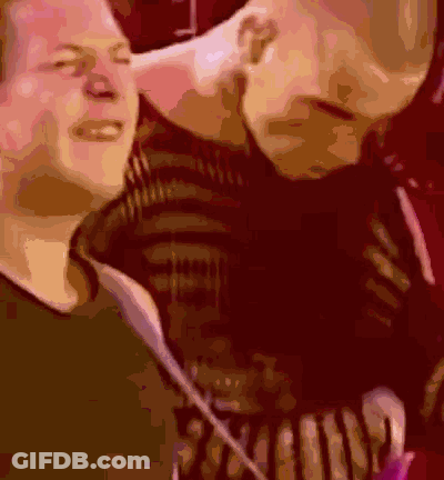 A Blurry Picture Of A Man Kissing Another Man 'S Neck GIF