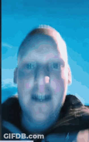 A Blurry Picture Of A Man 'S Face Against A Blue Sky GIF