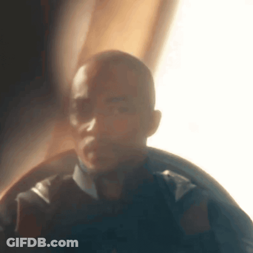 A Blurry Picture Of A Man 'S Face In A Dark Room . GIF