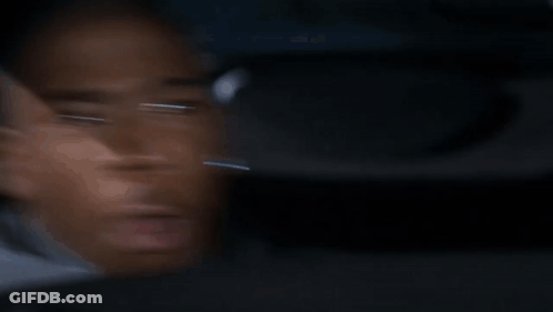 A Blurry Picture Of A Man 'S Face Looking Out A Car Window . GIF