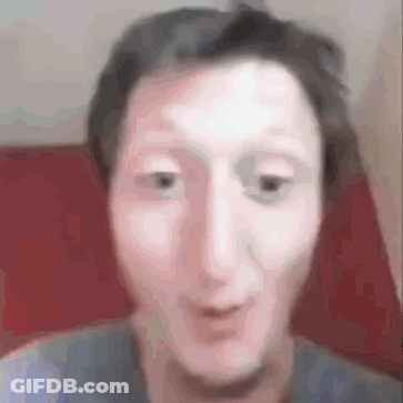 A Blurry Picture Of A Man 'S Face Making A Funny Face While Sitting In A Chair . GIF