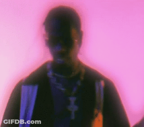 A Blurry Picture Of A Man 'S Face With A Purple Background . GIF