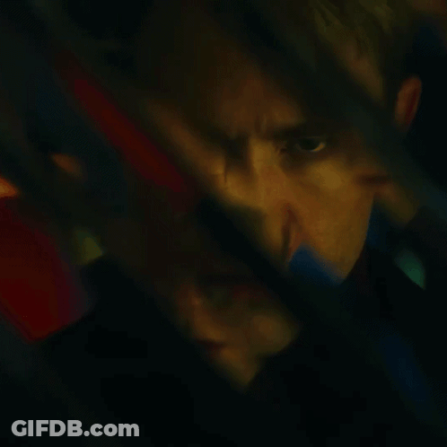 A Blurry Picture Of A Man 'S Face With A Red And Blue Background GIF