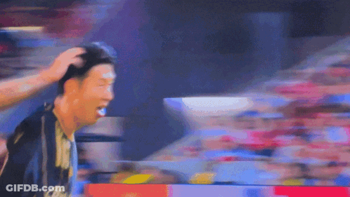 A Blurry Picture Of A Man 'S Head With A Crowd In The Background Behind Him GIF