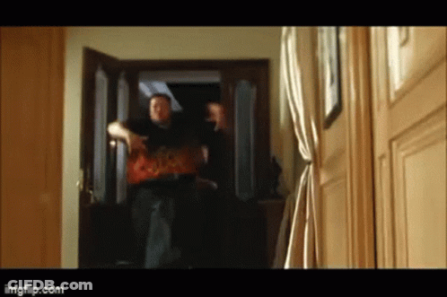A Blurry Picture Of A Man Standing In A Doorway With Imgflip.com In The Lower Right Corner GIF