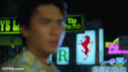 A Blurry Picture Of A Man Standing In Front Of A Neon Sign That Says The Fun Pub GIF