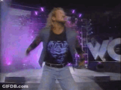 A Blurry Picture Of A Man Standing In Front Of A Wow Sign GIF