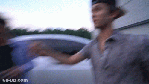 A Blurry Picture Of A Man Standing Next To Another Man GIF