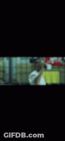 A Blurry Picture Of A Man Taking A Selfie In A Mirror . GIF