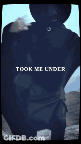 Blurry Man Wearing Black Hat And Cape GIF